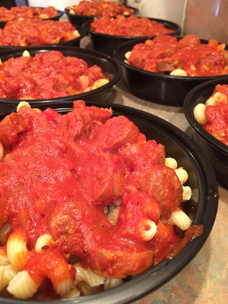 slow cooked sausages sliced over cavatappi with red sauce